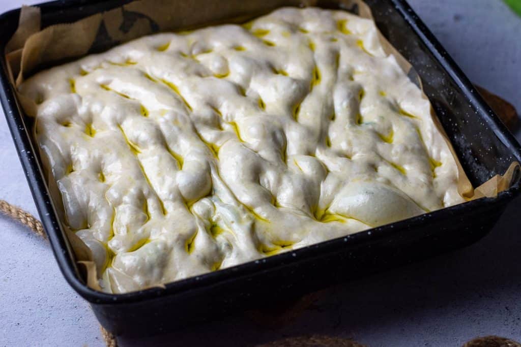 Dimpled garlic bread sourdough focaccia before baking.