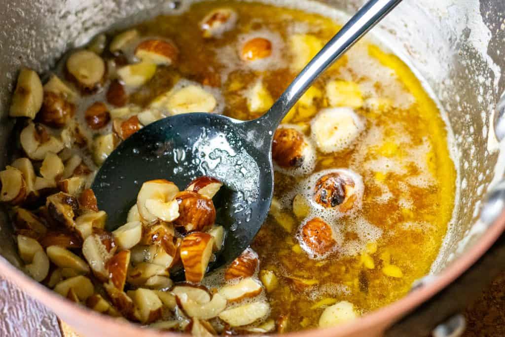 Chopped hazelnuts in browned sage-infused butter.