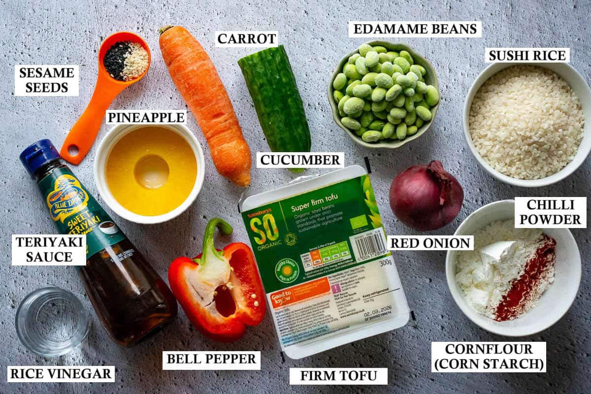 Labelled ingrediens for teriyaki tofu poke bowls on a light grey surface.