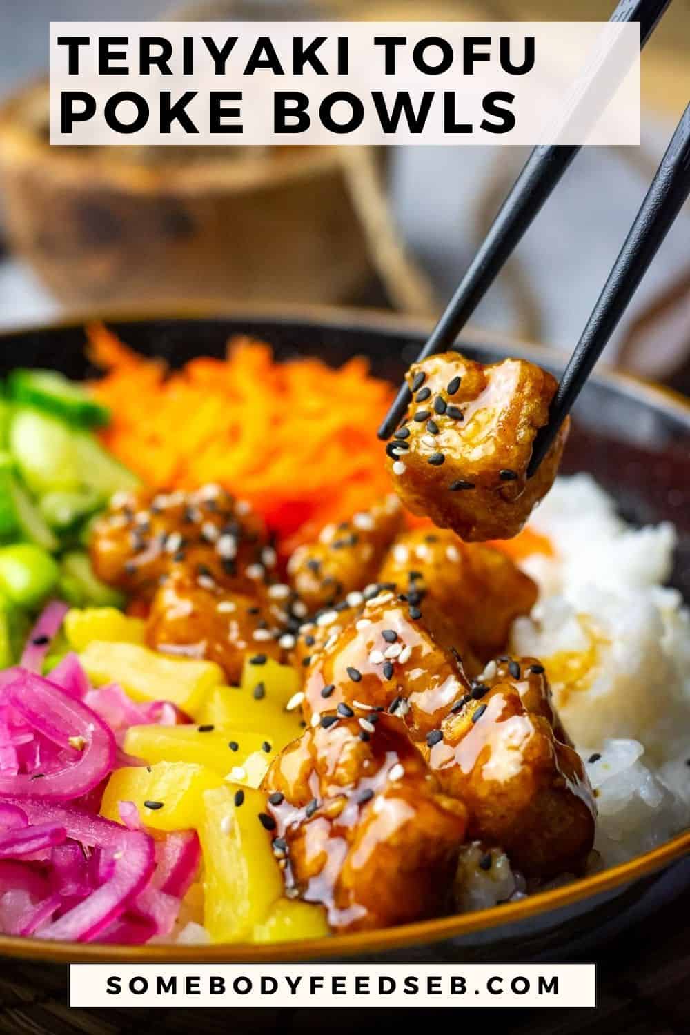 A piece of teriyaki tofu being picked up from a poke bowl. Pin for Pinterest.