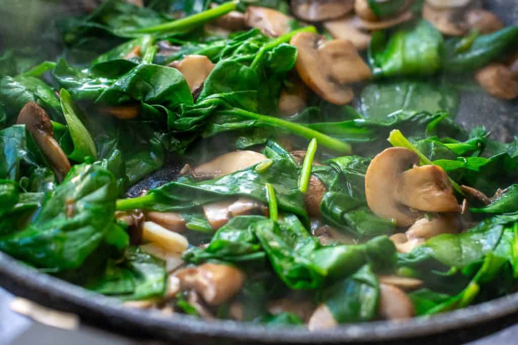 Wilted spinach in a mushroom pan.
