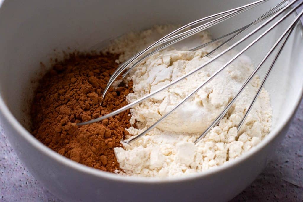 Combining dry ingredients in a medium bowl.