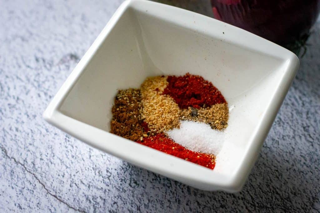 Spices and seasonings for blackened fish in a small white bowl.