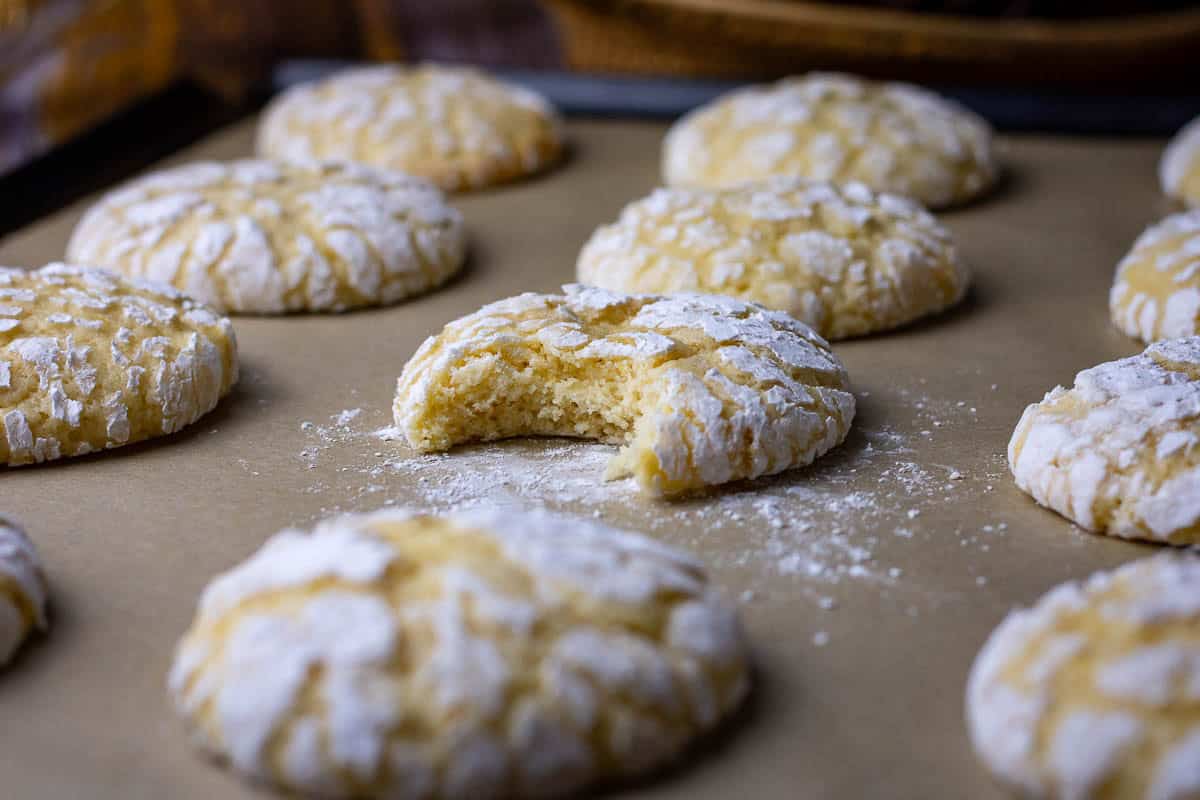 A sourdough lemon crinkle cookie missing a bite.