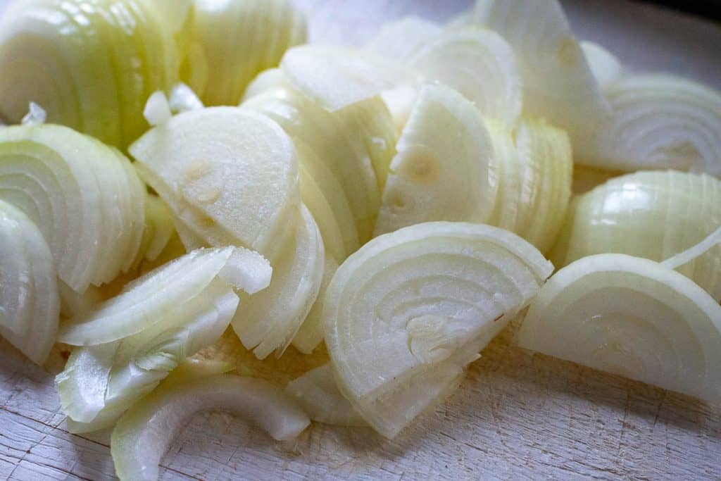 Sliced onion on a wooden board.