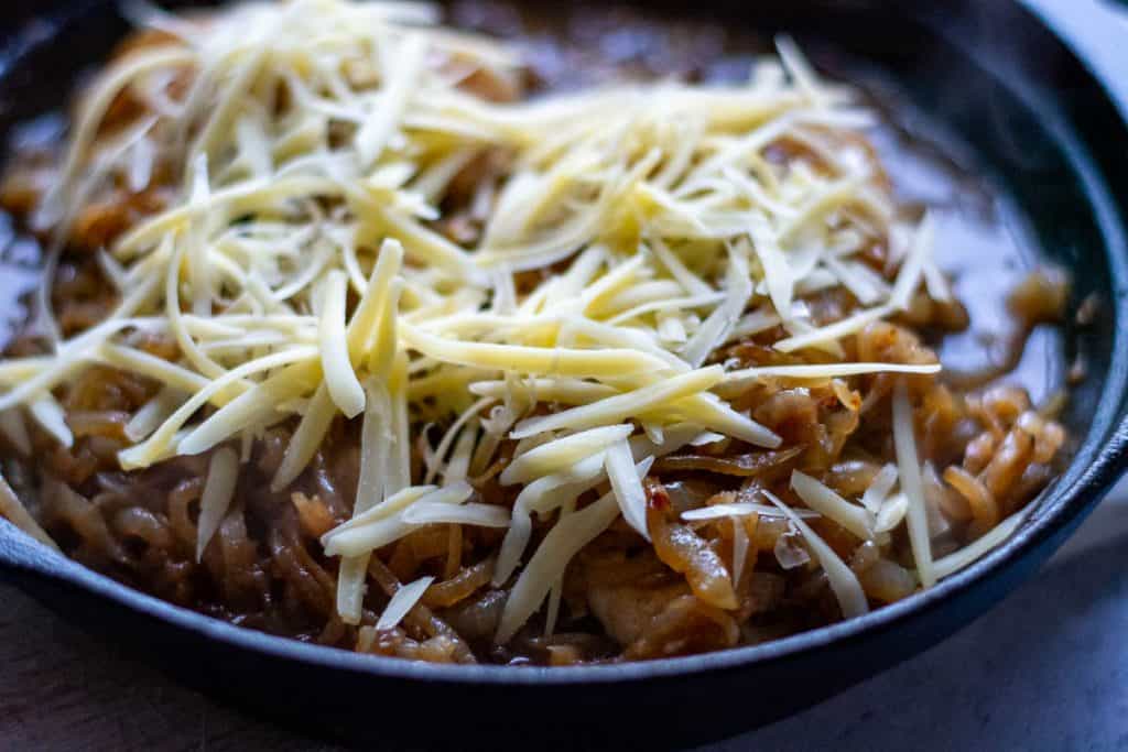 Grated Gruyere cheese on top of the caramelised onion chicken breasts.