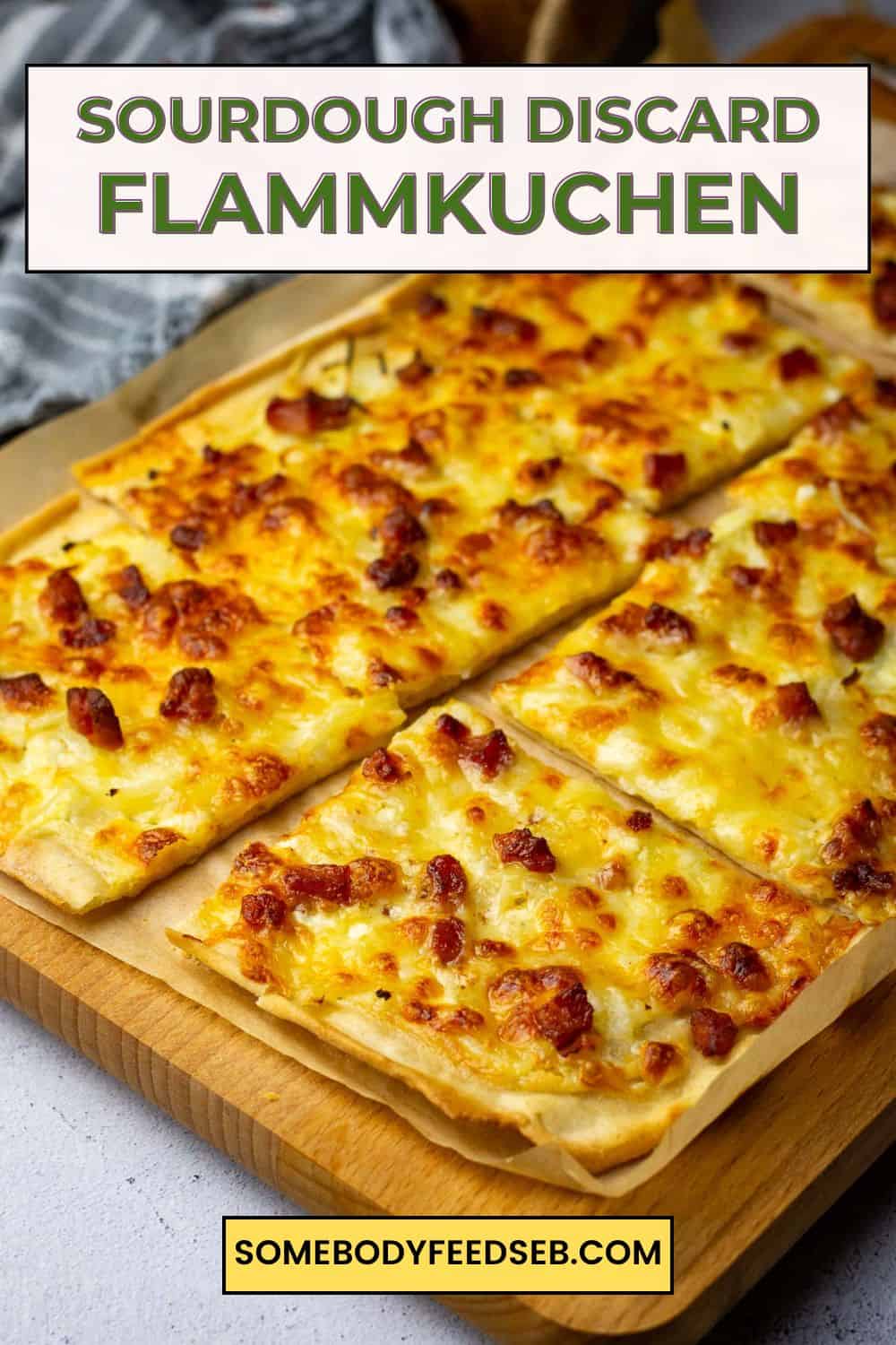 Sourdough Flammkuchen, also known as Tarte Flambee, cut into squares on a wooden board. Pin for Pinterest.