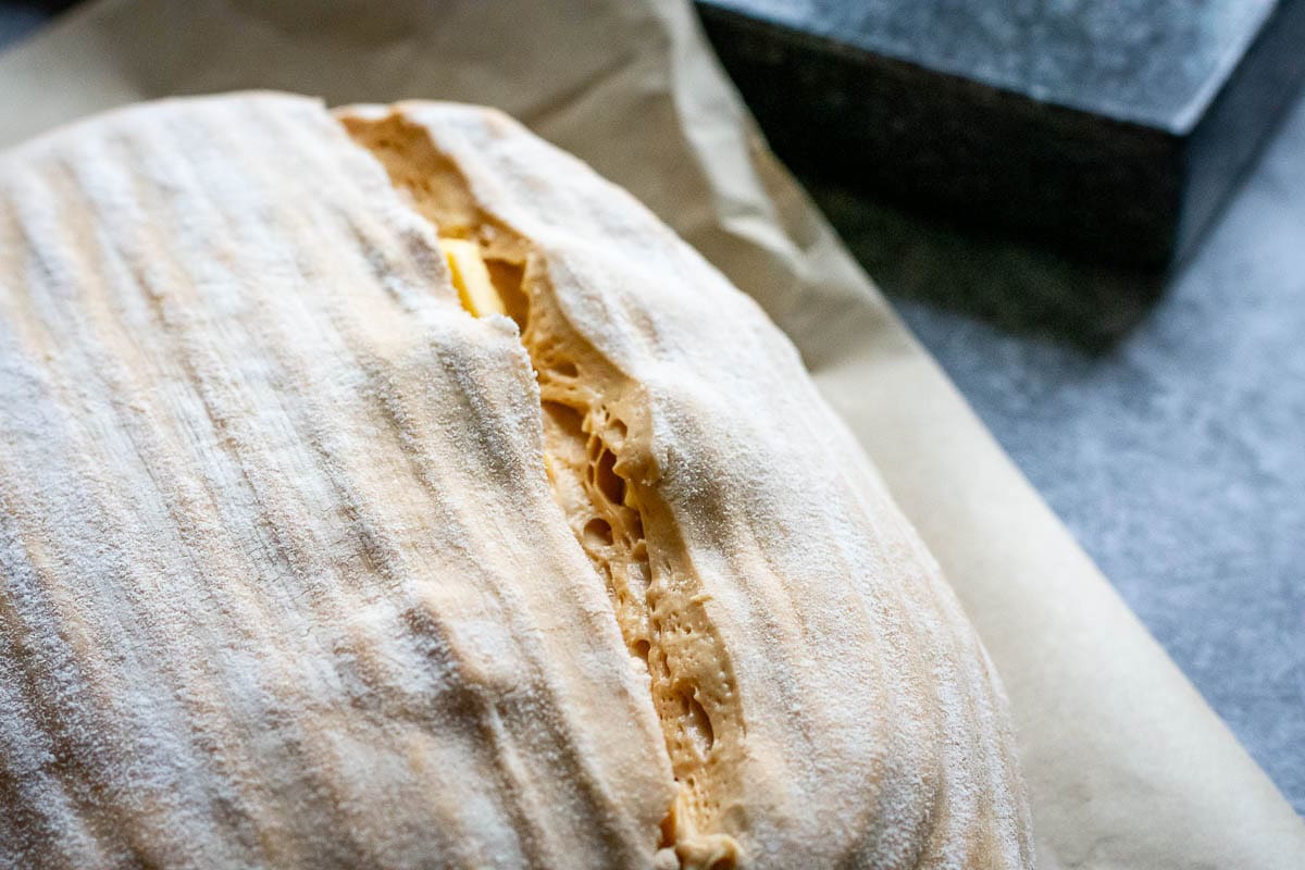 Scored sourdough bread before baking.