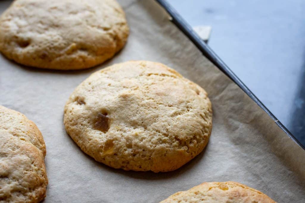 Sourdough ginger cookie straight out of the oven before dropping them to create crackled tops.