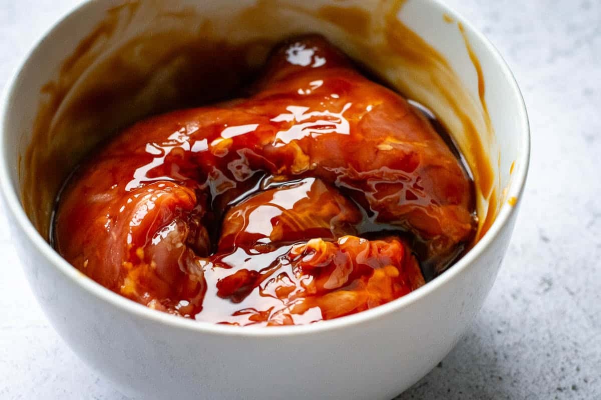 Pork tenderloin marinating in teriyaki sauce.