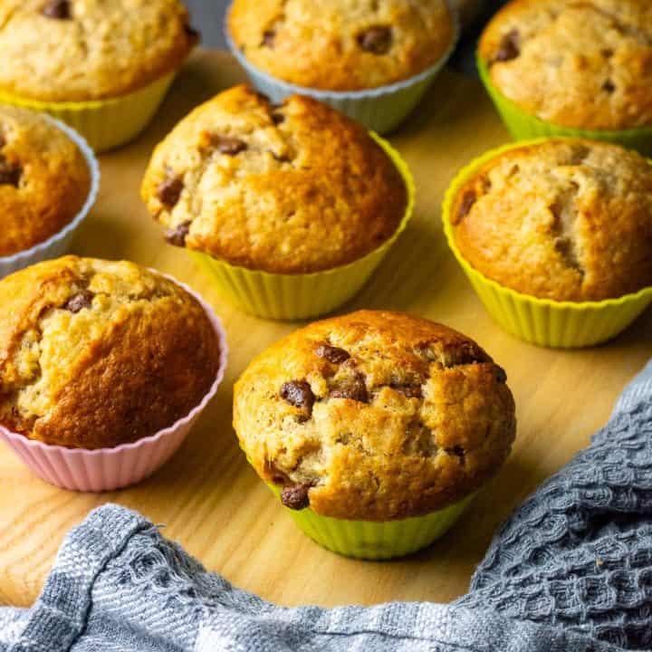 Sourdough Banana Muffins with Chocolate Chips arranged on a wooden board.