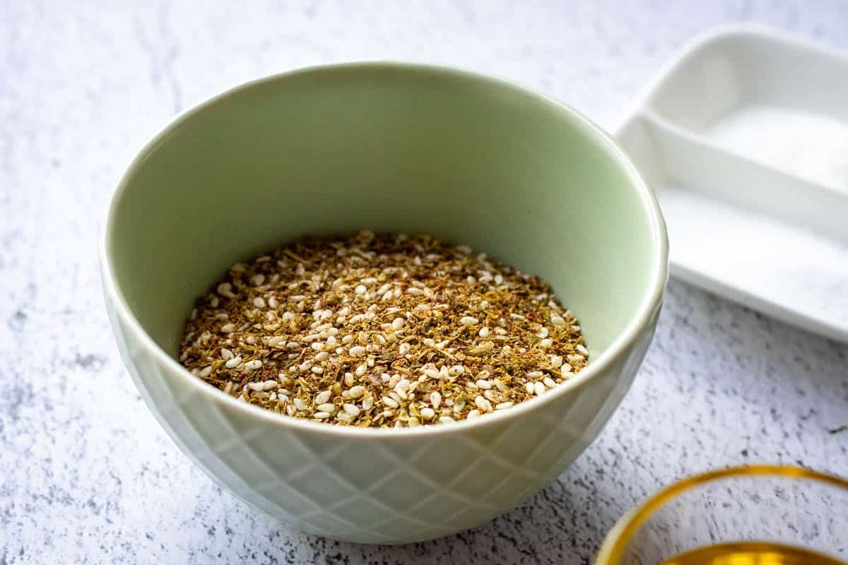 A pale green bowl with za'atar blend in it.