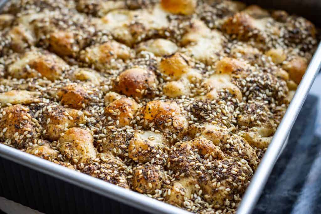 Baked manakeesh inspired sourdough foccaccia in a baking tray.