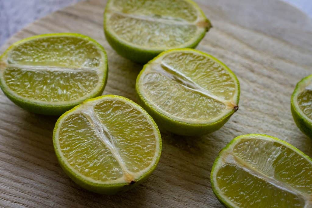 Lime halves on a wooden board.