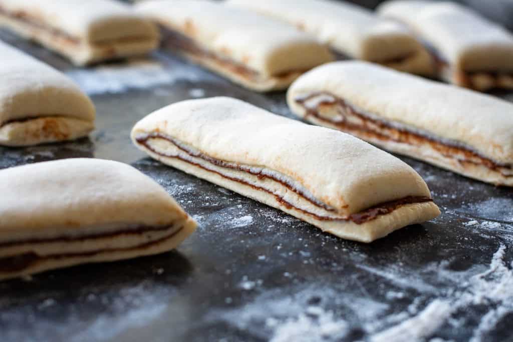 Sourdough chocolate roll dough cut into thin strips.