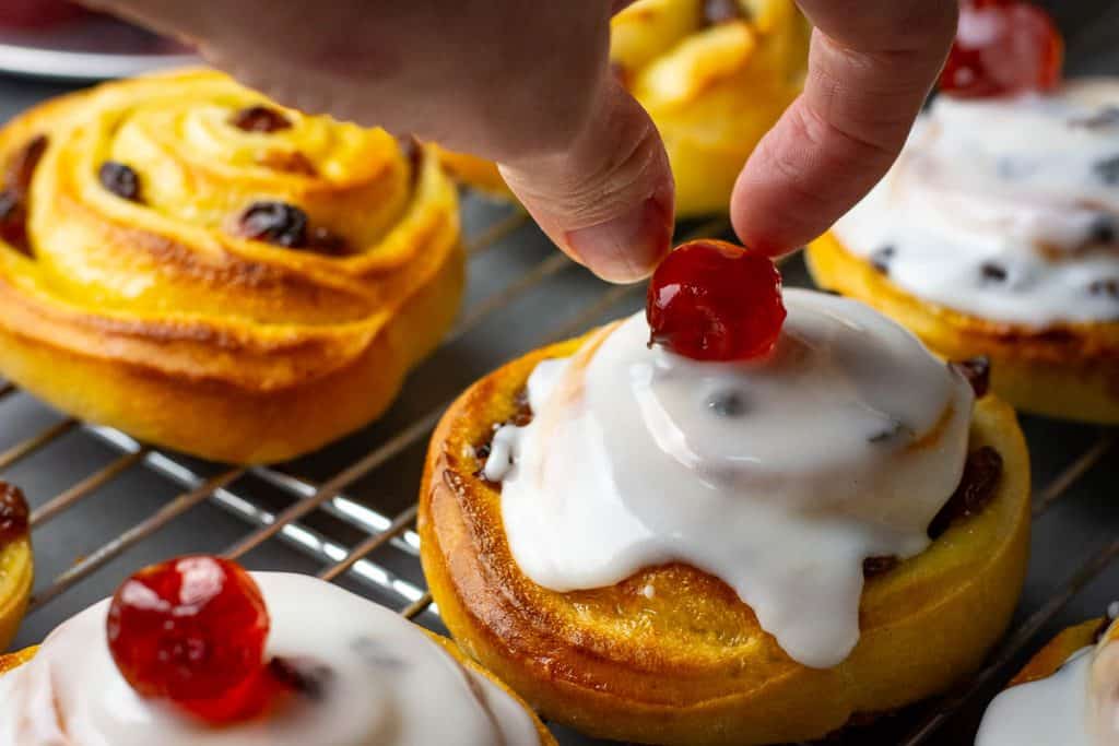 Topping sourdough Belgian buns with cherries.