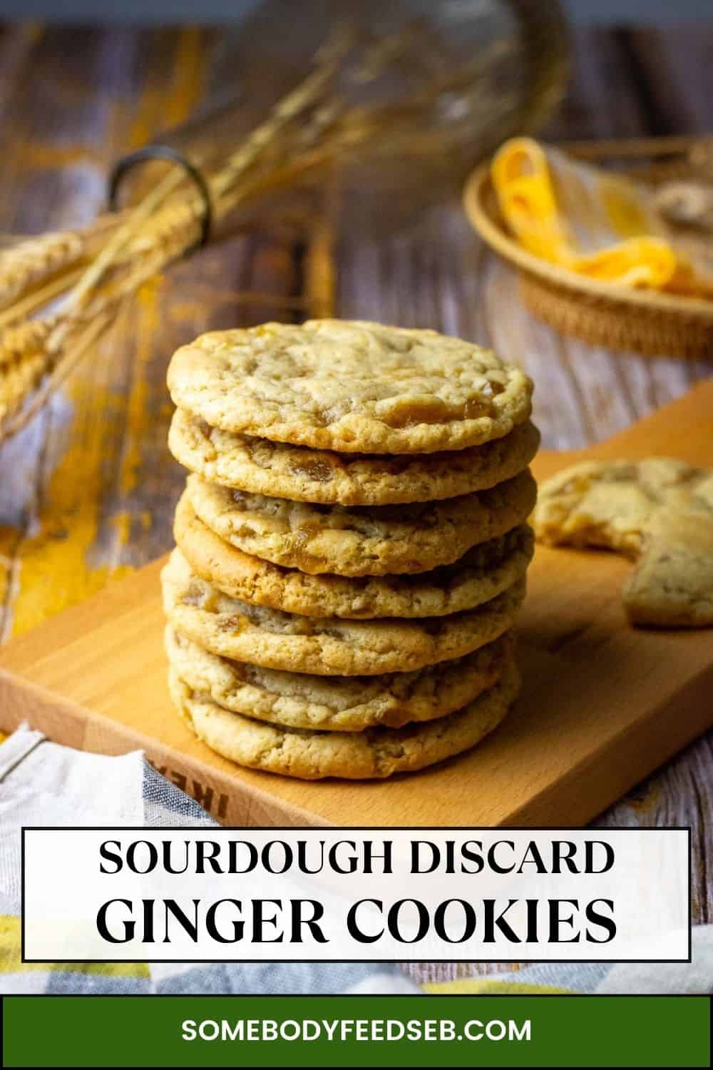A tall stack of sourdough discard ginger cookies on a wooden board. Pin for Pinterest.