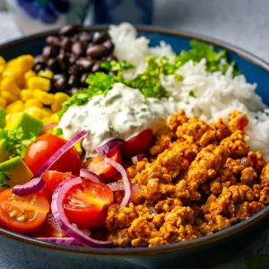 Ground Turkey Burrito Bowl topped with lots of veggies.