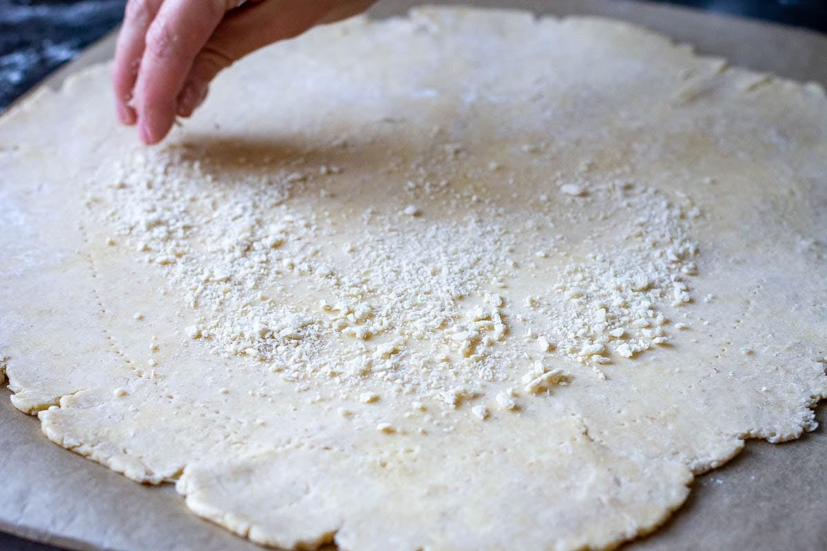 Breadcrumbs scattered on top of the pastry to asborb excess moisture from strawberries.