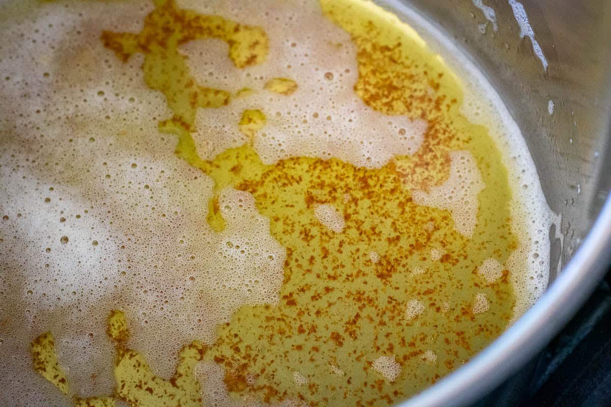 Brown speckles forming at the base of the pan whilst browning the butter.