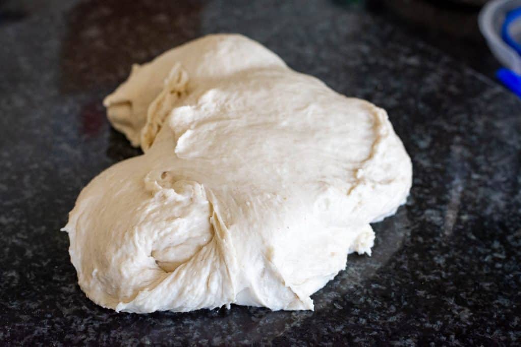 Mixed dough for Neapolitan Sourdough Crust on a work surface.