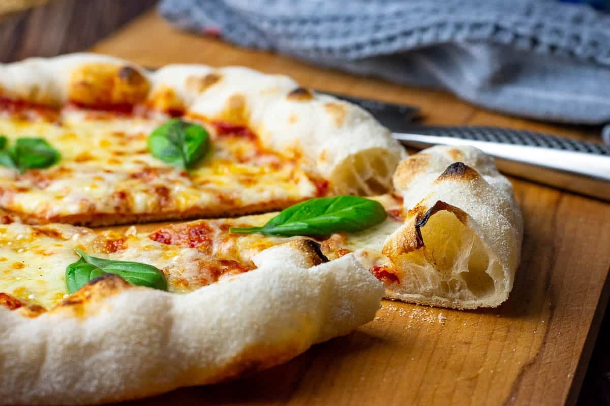 Sourdough Margheritta pizza on a wooden board.