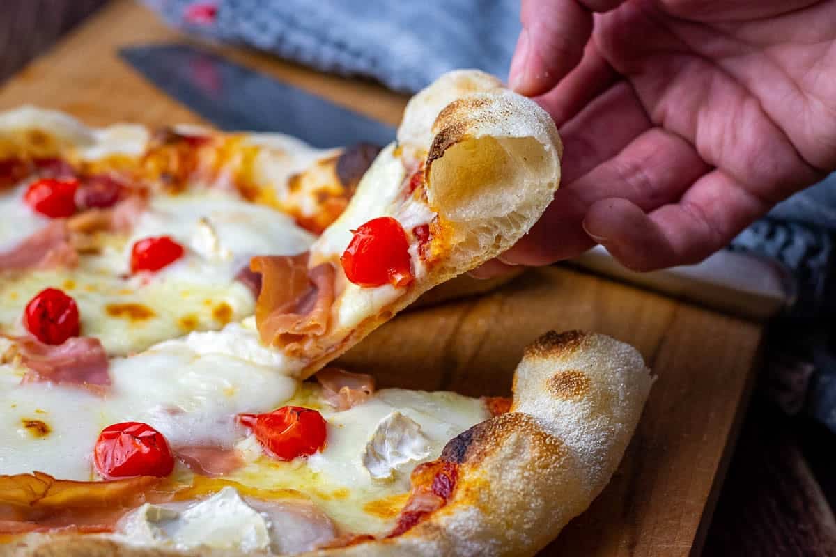 Neapolitan Sourdough Pizza topped with mozzarella, prosciutto, pearl peppers and goat cheese.