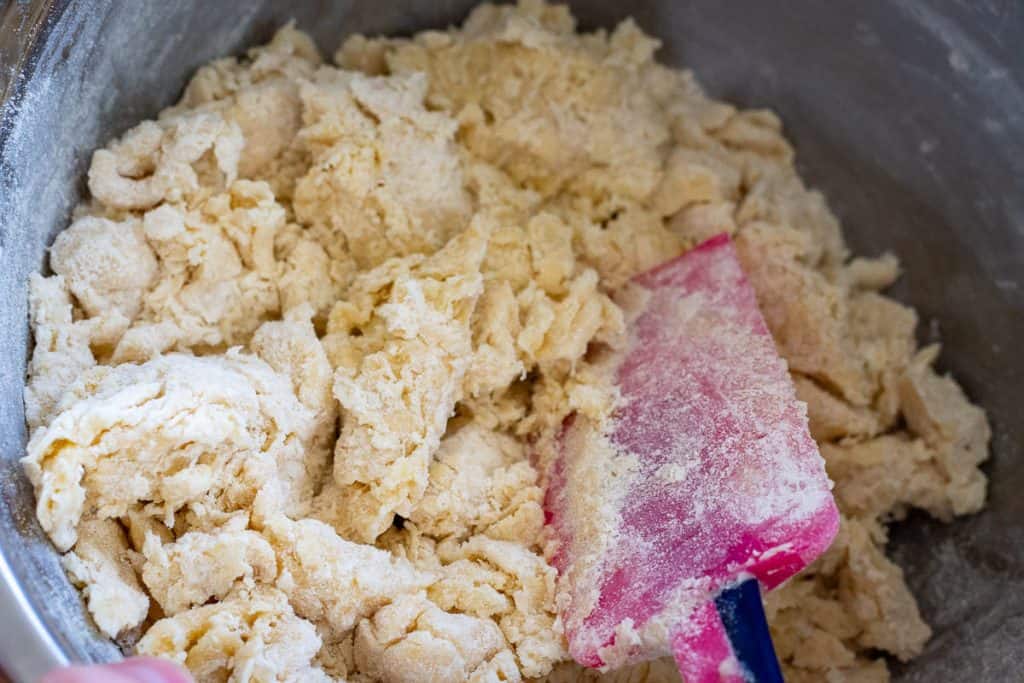 Folding dry ingredients into the wet ingredients.