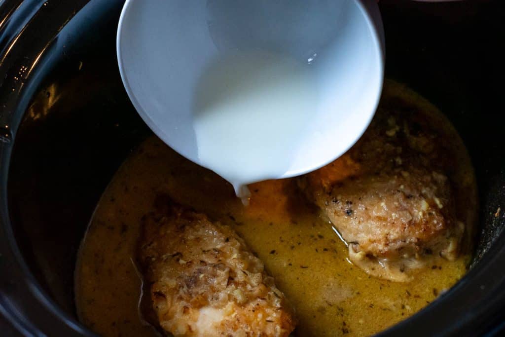 Pouring cornflour slurry into the honey mustard sauce.