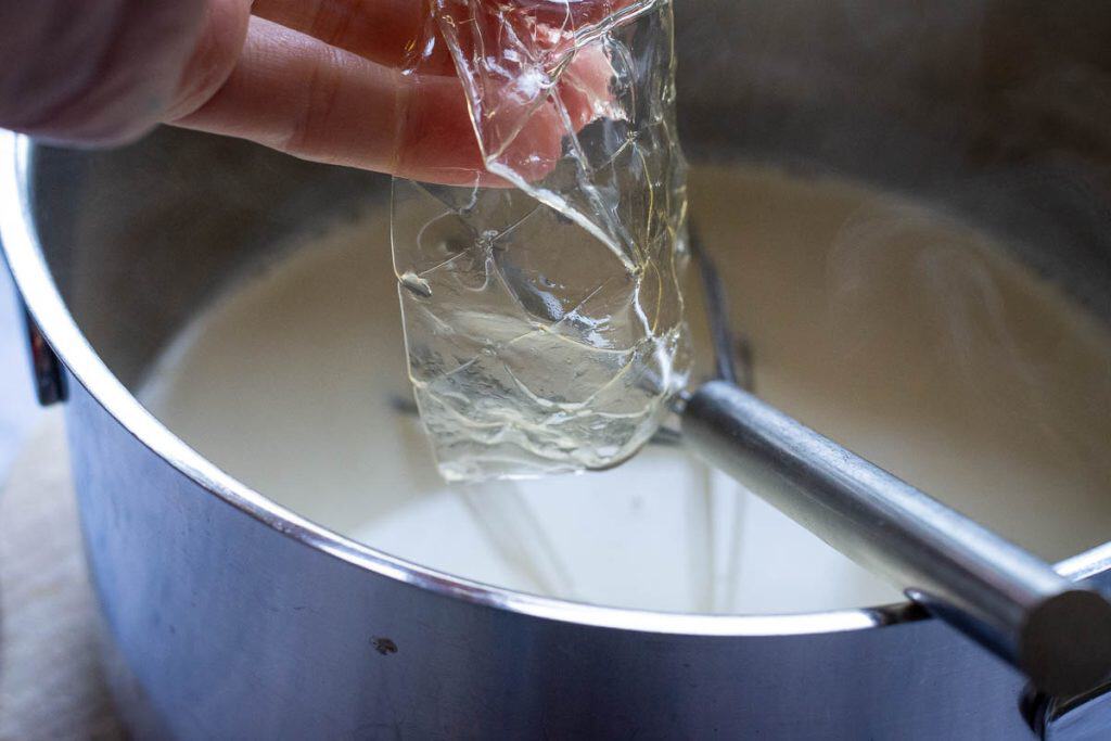 Adding soaked leaf gelatine to the cream mixture.