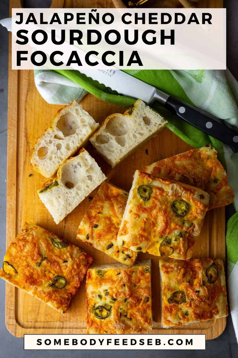 Jalepeno Cheddar Sourdough Focaccia sliced into squares on a wooden cutting board.