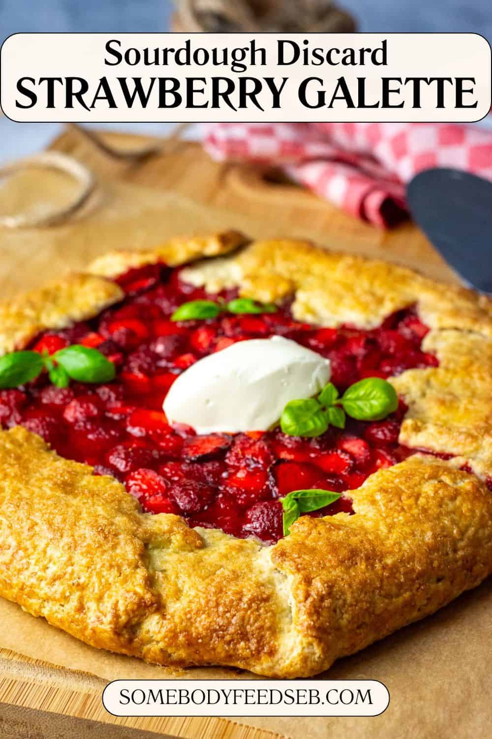 Sourdough Galette with strawberries and a dollop of creme fraiche on a wooden board. Pin for Pinterest.