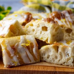 Sweet Lemon Sourdough Focaccia sliced and placed on a wooden board.