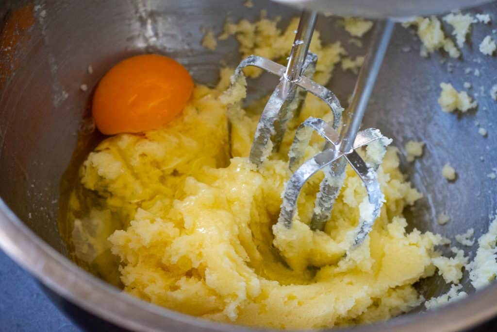 Creaming the butter with eggs.