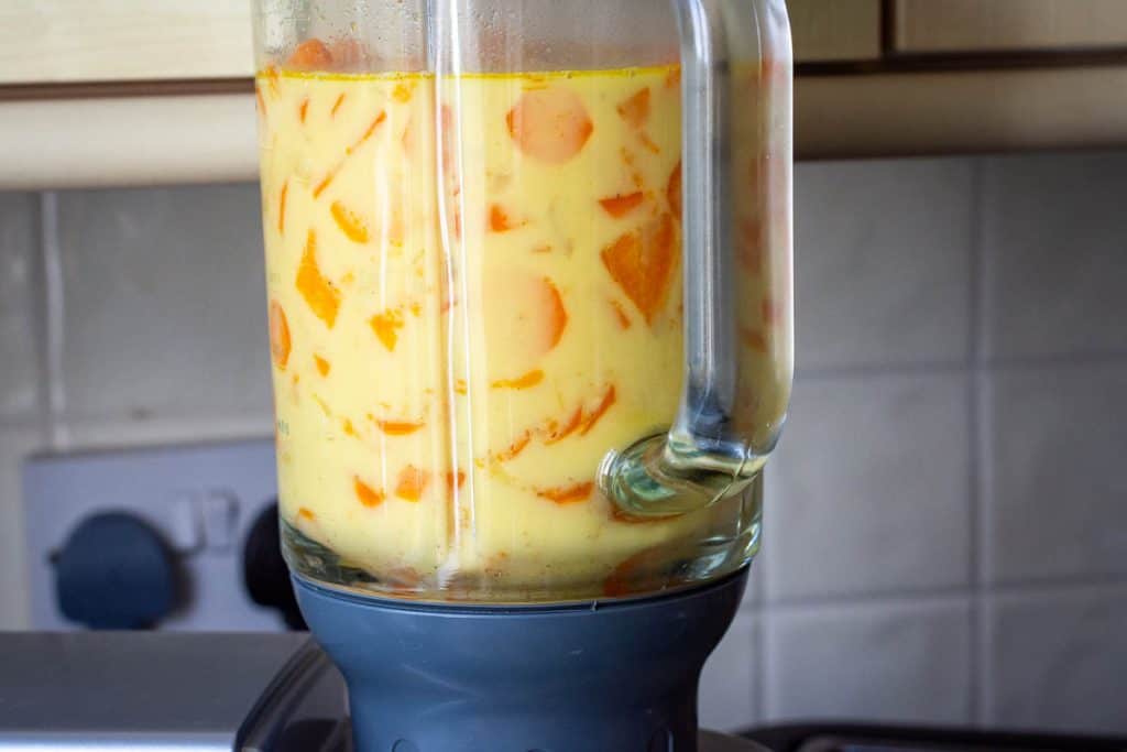 Sweet potato and carrot soup in a kenwood liquidiser about to get blended.