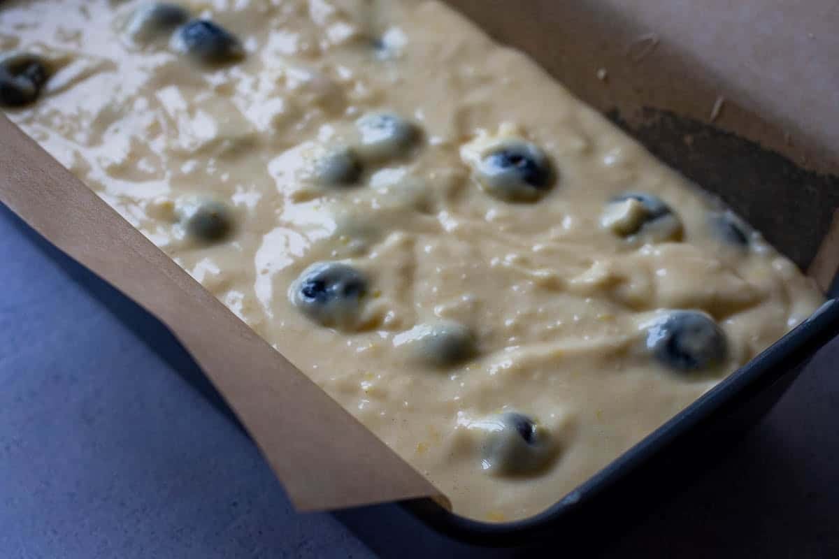 Sourdough Blueberry cake batter in a lined loaf pan.