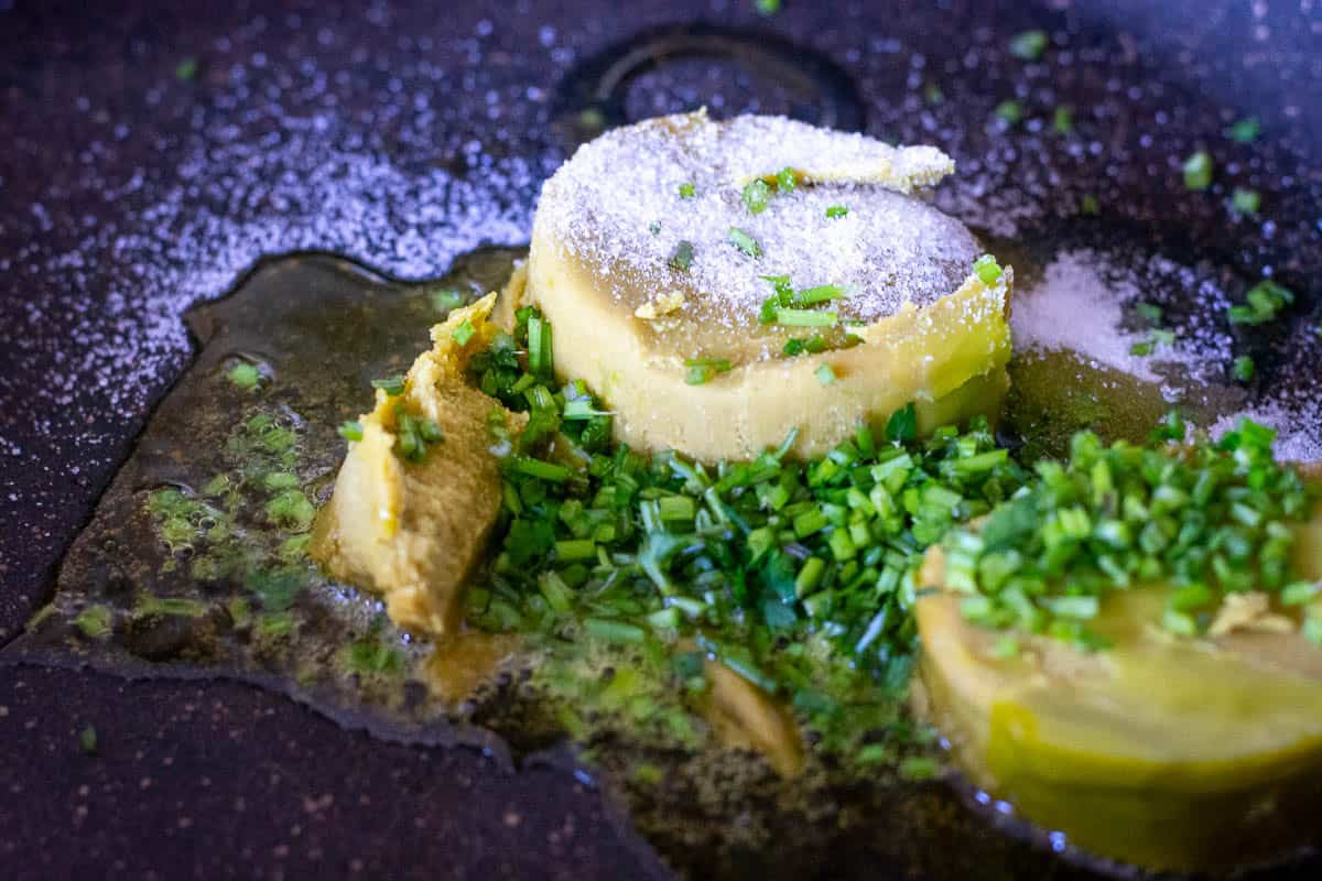 Thai green curry paste, sugar and aromatics in a large frying pan.