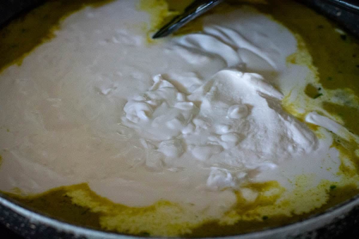 Coconut Milk added to the pan to make the Thai Green Curry sauce.