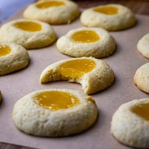 Sourdough Thumbprint Cookies With lemon curd filling, one of which is already missing a bite.