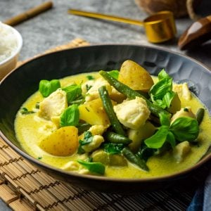 A bowlful of Thai Green Fish Curry with green beans, potatoes and creamy coconut sauce.