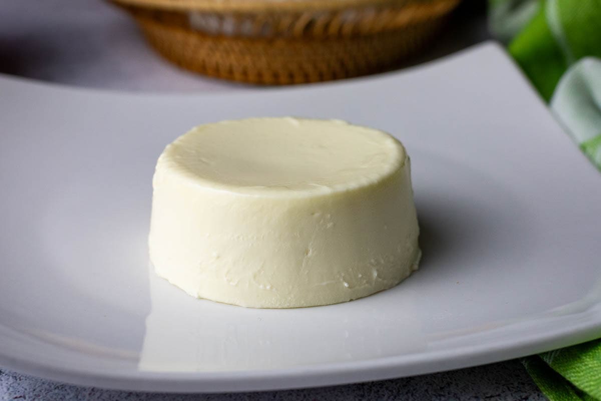 Unmouldedpanna cotta on a white plate.