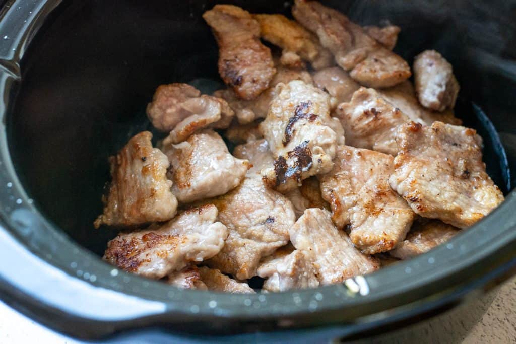 Fried pork in a slow cooker bowl.