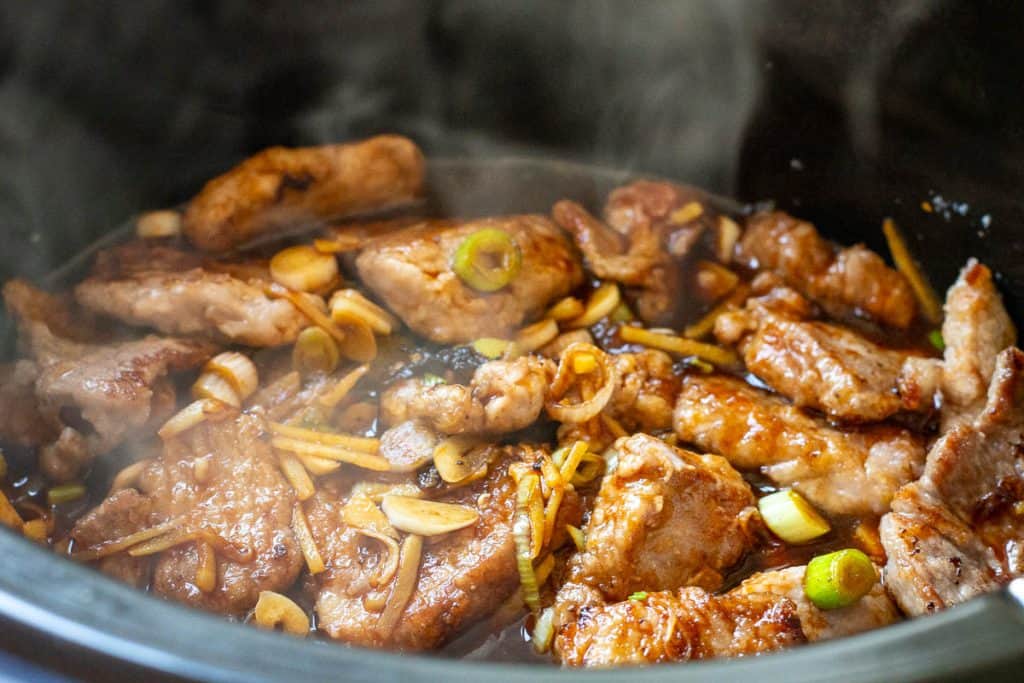 Mongolian pork ingredeints in a bowl of a slow cooker.