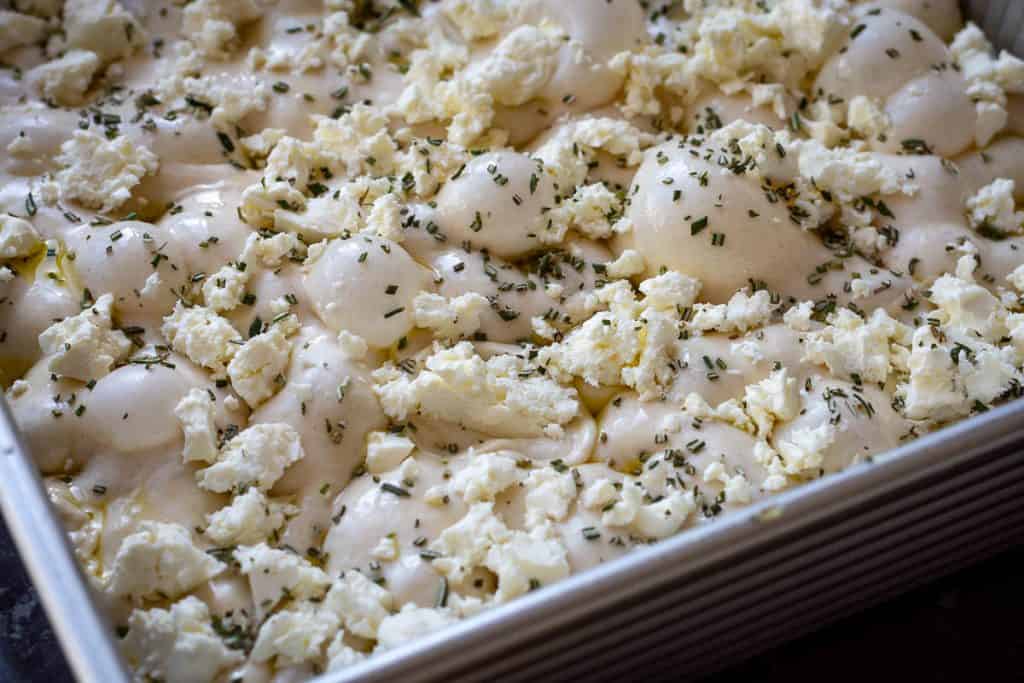Dimpled sourdough focaccia with feta and rosemary.