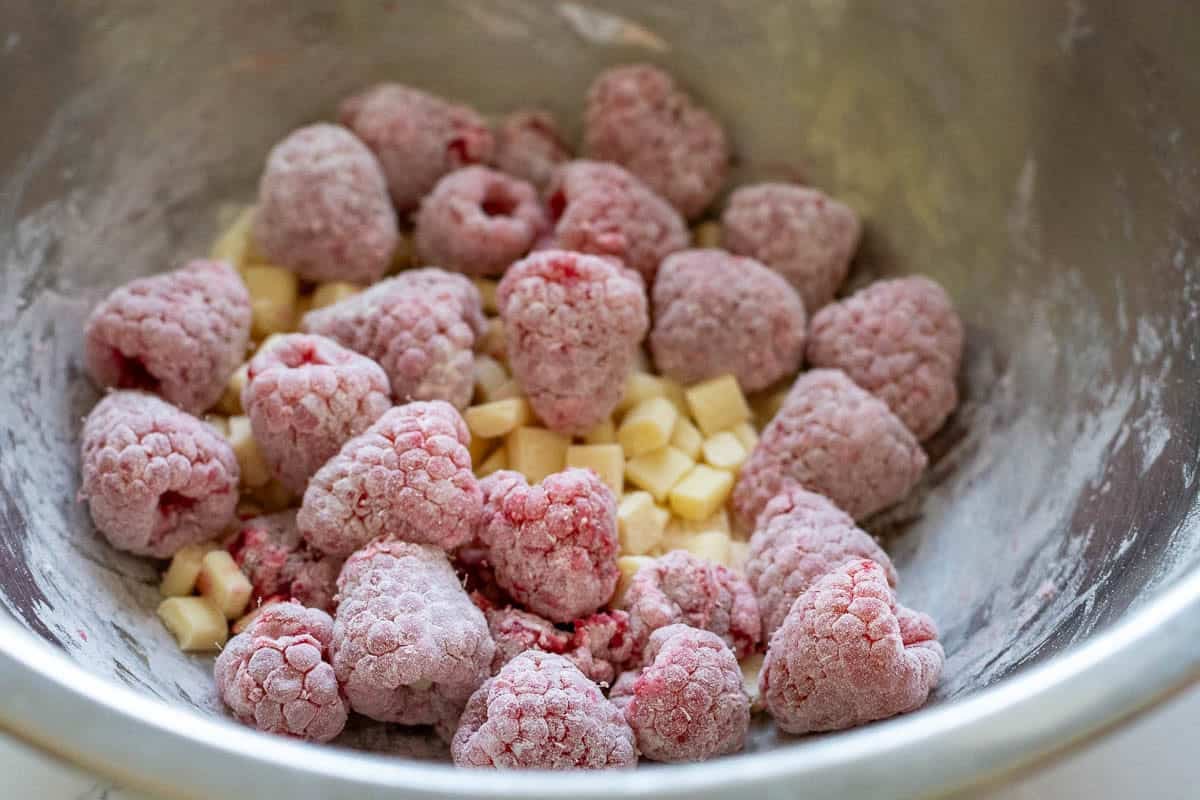 Raspberries and white chocolate chips tossed with flour.
