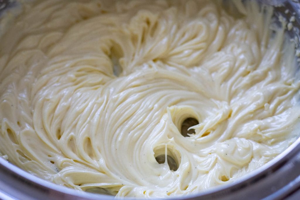 White chocolate cream cheese frosting being whisked for the raspberry sourdough cupcakes