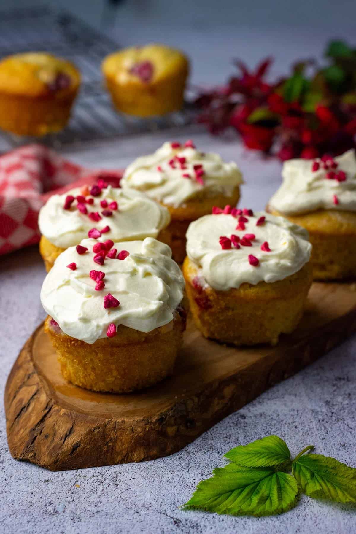 Sourdough Raspberry Cupcakes with icing spread on top and topped with freeze fried raspberries.