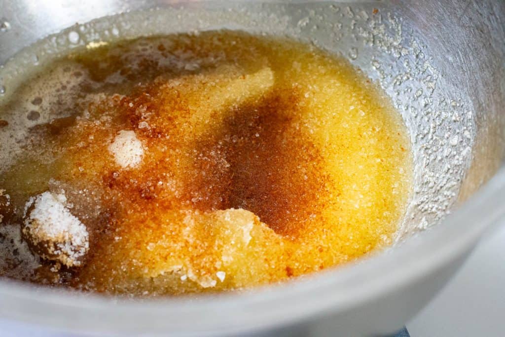 Two types of sugar and brown butter in a large mixing bowl.