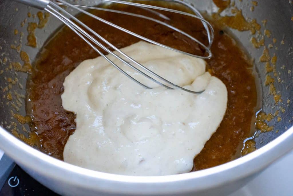 Whisking the sourdough discard into the butter egg and sugar mixture using balloon whisk.