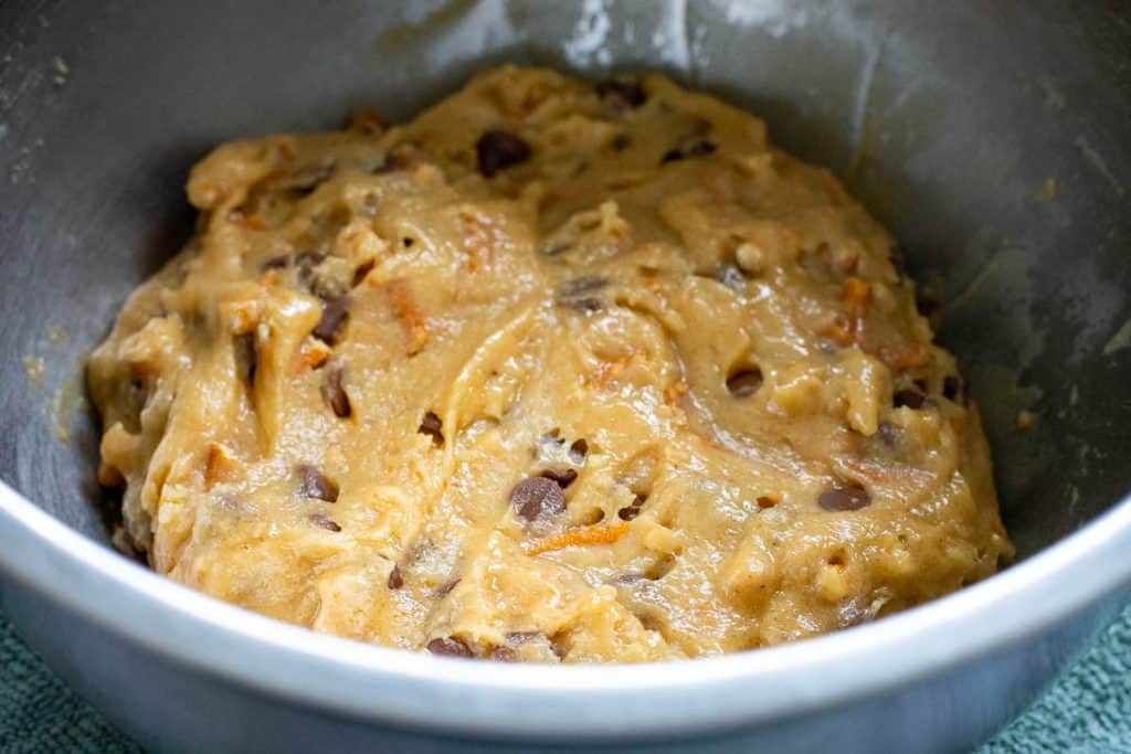 Chocolate chip and pretzel cookie dough in a large metal bwol ready for chilling.